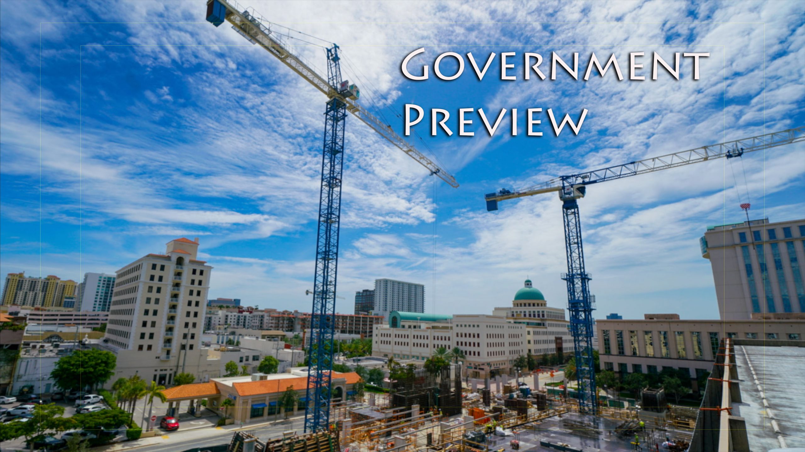Cranes next to buildings on a sunny day text reads Government Preview.